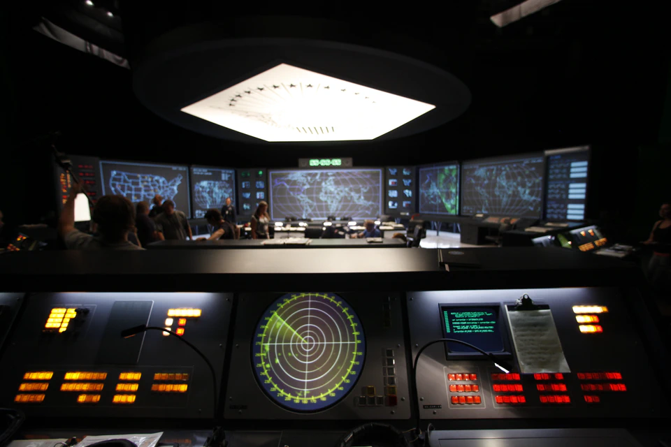The X-Men: Apocalypse Pentagon set with a projected video wall and illuminated command consoles.